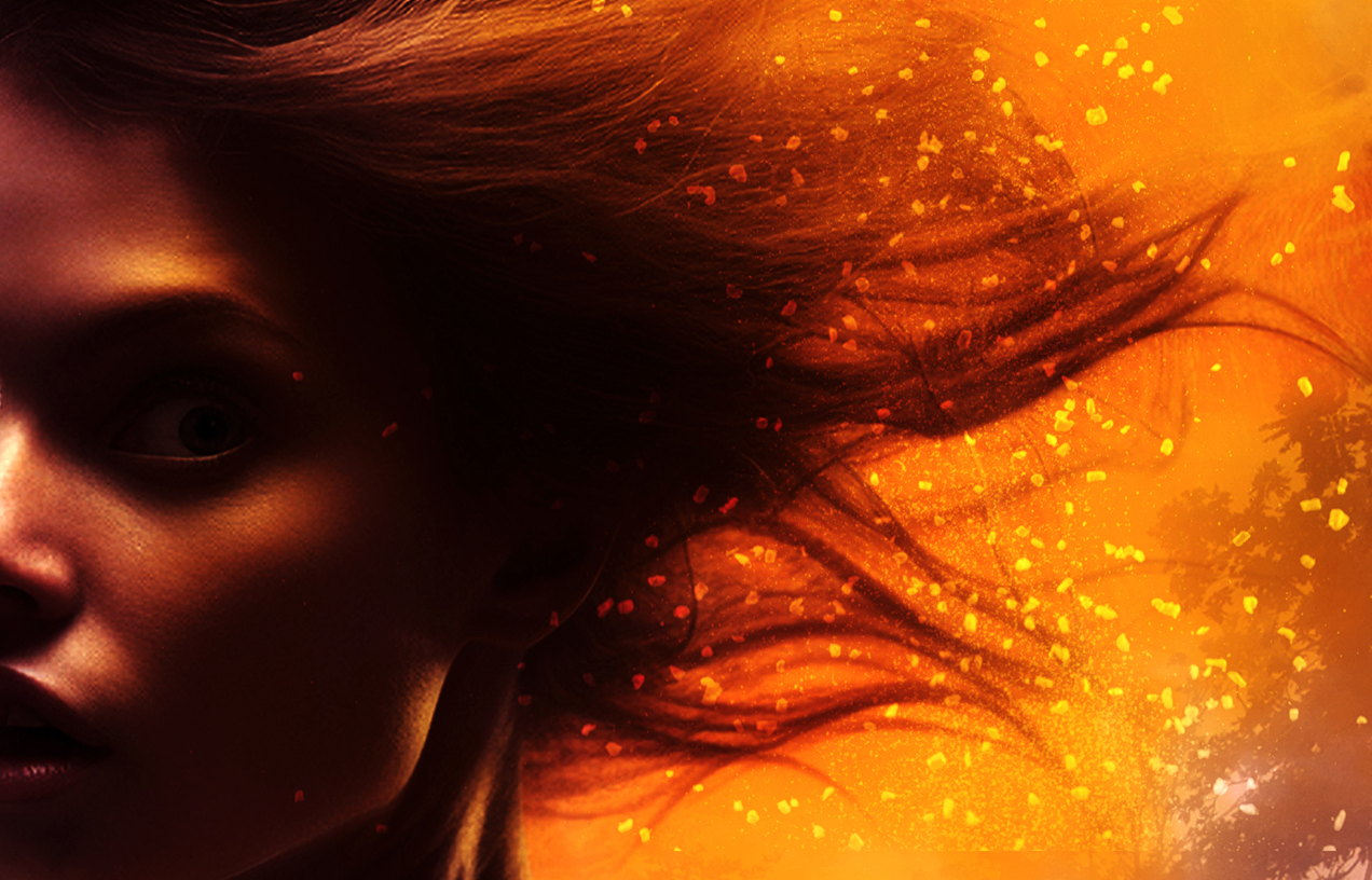 a partial woman's face in shadow with windblown hair and fiery embers